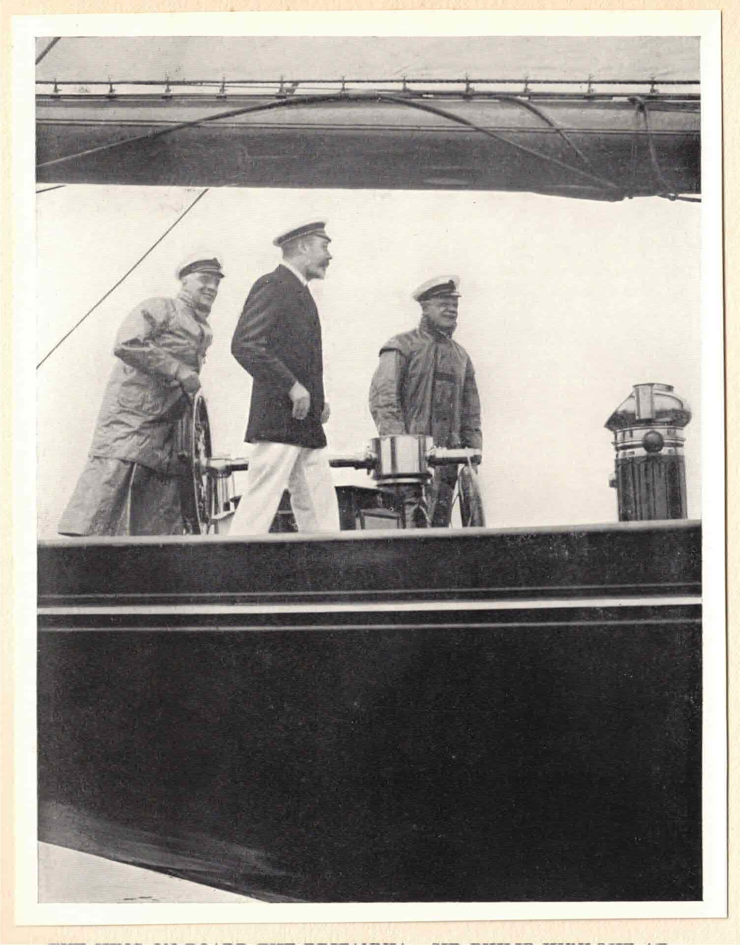 King George V eyes the competition from a vantage point close to the helm